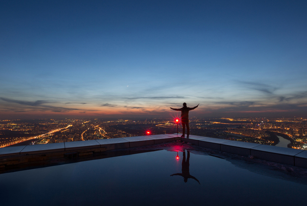 person looking out into the world below