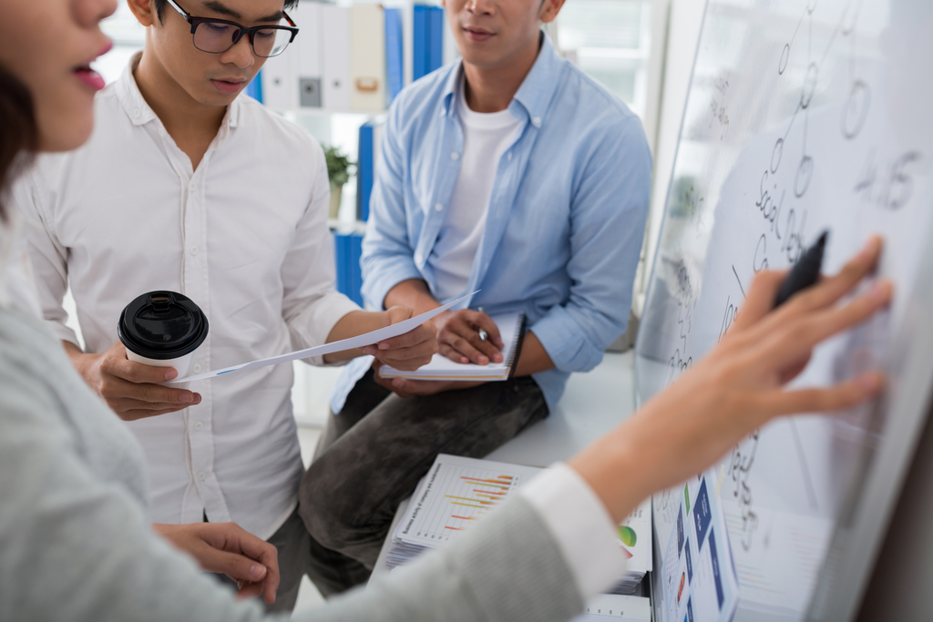 People working at a whiteboard