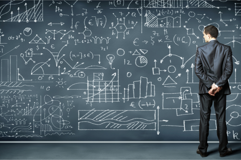 man writing on blackboard